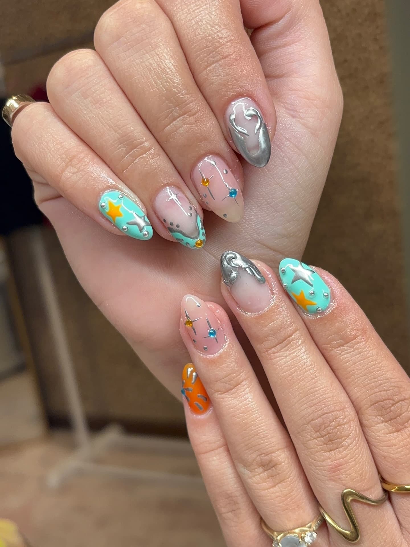 Nail set with stars and colorful chrome accents